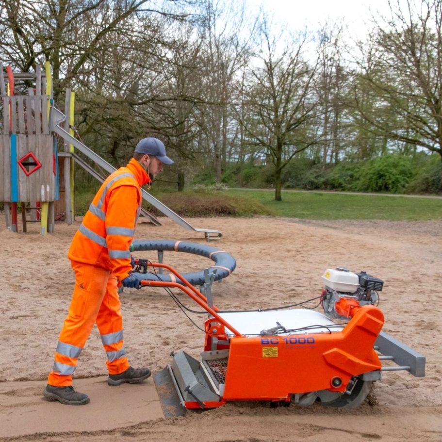 Sandreiniger BC1000 bei der Sandreinigung auf einem Spielplatz. 